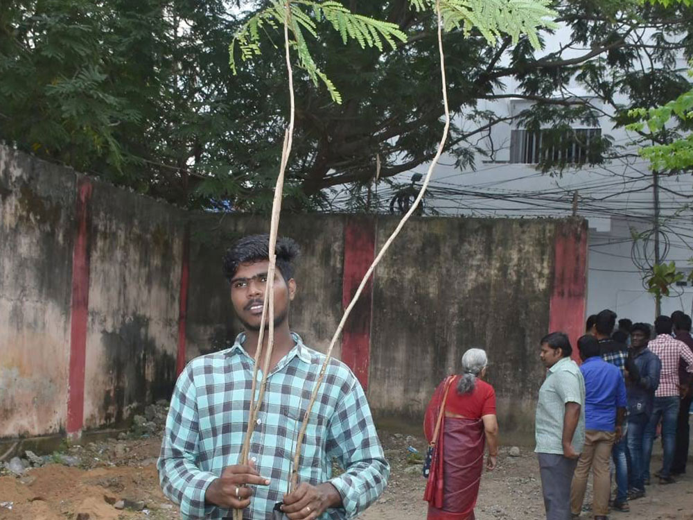 Visually Challenged Darshini student carrying a sapling. 